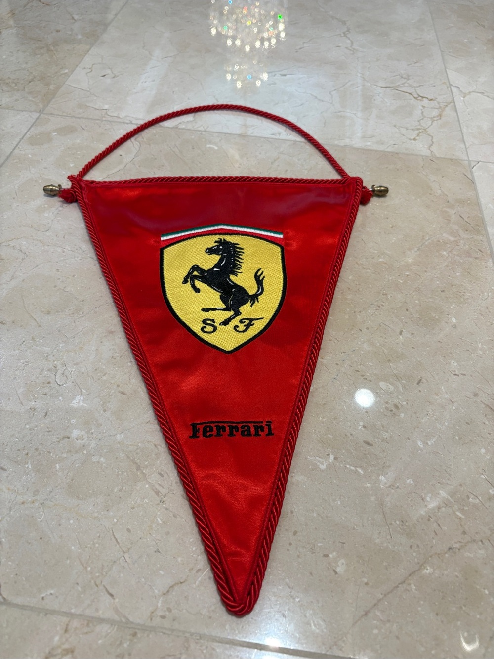 Ferrari red triangular pennant with yellow shield and black horse